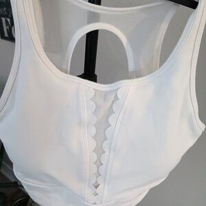A preowned CALIA sports bra in pure white with extra coverage and detail.